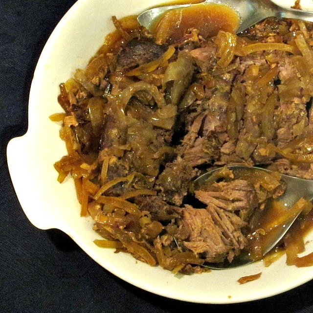 Sliced pot roast and gravy in serving dish