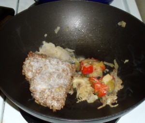 Frzen cooked meat and vegetables on pan