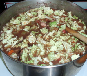 Bean soup with cabbage being added