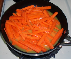Carrots boiling in OJ - inhabitedkitchen.com