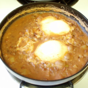 eggs poaching in beans