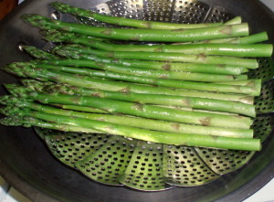 Steaming asparagus spears - www.inhabitedkitchen.com