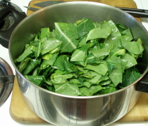 Filling the pot with chopped collards - www.inhabitedkitchen.com