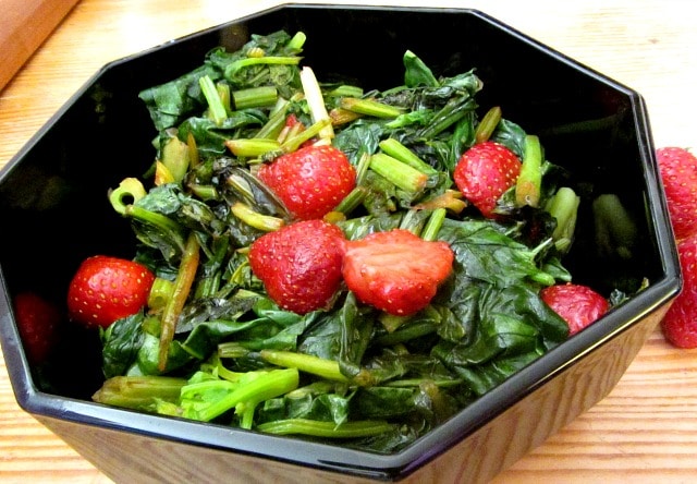 Sweet red strawberries nestled in savory sauteed spinach - a wonderful vegetable dish to celebrate the beginning of summer!