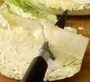 Cutting the core out of the cabbage - www.inhabitedkitchen.com
