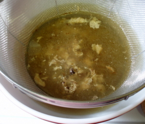 Straining Stock - www.inhabitedkitchen.com