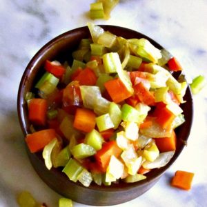A dish of prepared mirepoix, ready to use in a recipe.