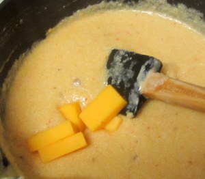 Adding cheese to thickened sauce - www.inhabitedkitchen.com