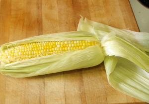 Shucking microwave steamed corn - www.inhabitedkitchen.com