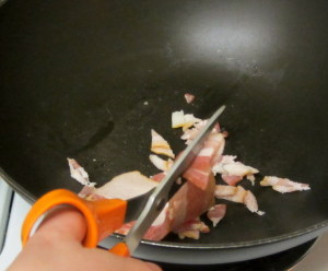 Cutting bacon with kitchen shears - www.inhabitedkitchen.com