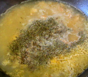 Adding herbs and seasosnign to broth - www.inhabitedkitchen.com