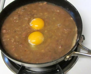 Breakfast - poaching eggs in beans - www.inhabitedkitchen.com