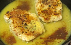 Adding orange juice and cinnamon to browned, spiced pork chops - www.inhabitedkitchen.com