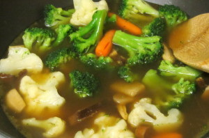 Mixed vegetables cooking in broth for hotpot - www.inhabitedkitchen.com