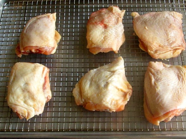 Raw chicken thighs ready to bake.