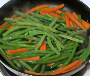 Adding frozen green beans to carrots - www.inhabitedkitchen.com