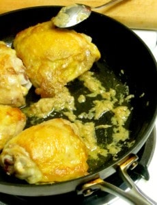 Chicken thighs braised in orange juice with a touch of ginger to add depth - easy and delicious! www.inhabitedkitchen.com