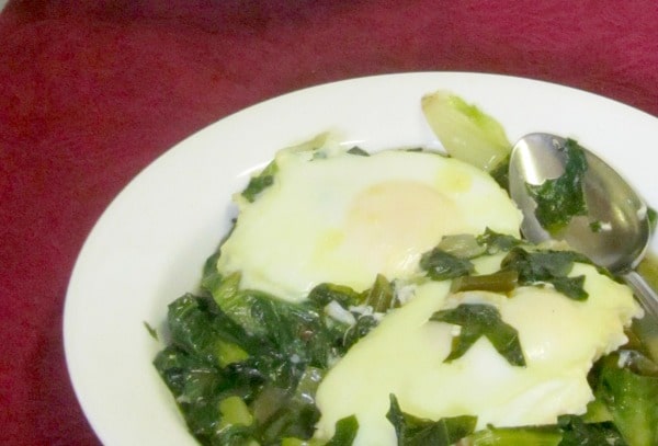 Simmer greens in broth and cook your eggs nestled right in them for a quick and easy meal of greens and eggs. www.inhabitedkitchen.com