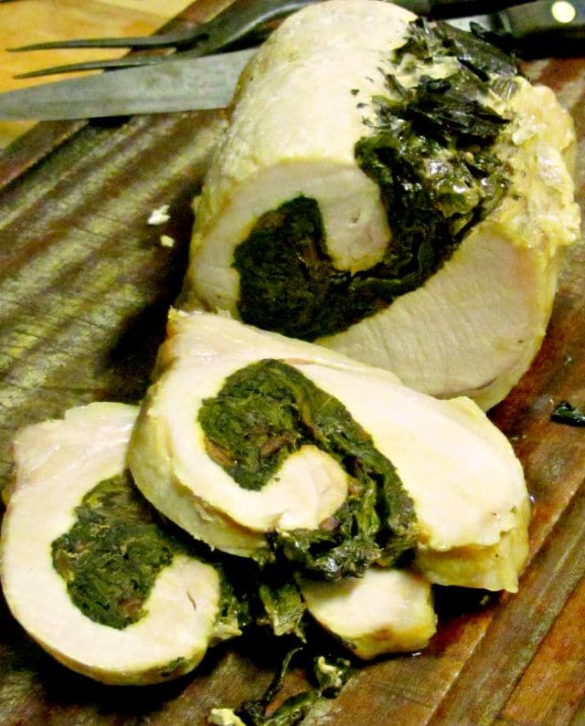 Slow cooked stuffed pork loin, with a green swirl of chard and herbs - and easy, decorative recipe even on a hot day. www.inhabitedkitchen.com