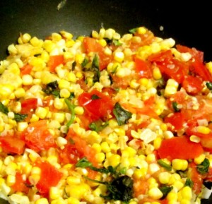 Very lightly saute fresh corn and tomatoes for a delicious and easy vegetable recipe that tastes like summer. www.inhabitedkitchen.com