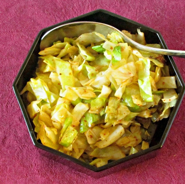 Simple sauteed cabbage with Harissa - a North African combination of hot peppers and spices, that adds both heat and complex flavor.
