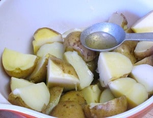 Potato salad made with an herbed oil and vinegar dressing - excellent for lunch boxes, picnics, and anyplace you want a lighter salad - and no mayo!