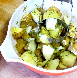 Potato salad made with an herbed oil and vinegar dressing - excellent for lunch boxes, picnics, and anyplace you want a lighter salad - and no mayo!
