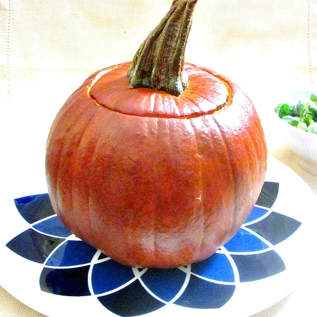 A vegan Stuffed Pumpkin gives everyone an impressive dish to serve at a Thanksgiving dinner.