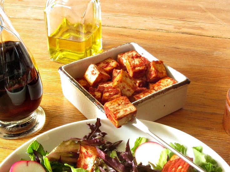 It's easy to season and bake tofu, which is delicious in salad or other recipes. No need to buy the packaged product, this suits your own taste!