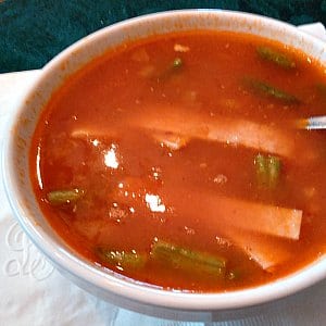 Bowl of tomato bases soup with strips of tortillas