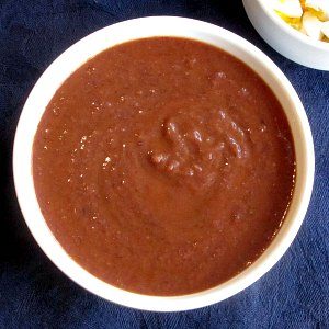 Bowl of Spicy Black Bean Soup, with a bowl of egg for garnish