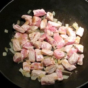 Saute onion and pork in pan.