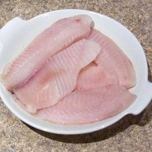 Tilapia fillets arranged in a baking dish