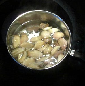 Garlic cloves in boiling water.