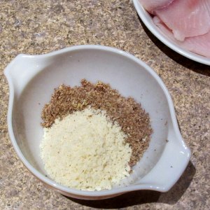 Ground pecans and grated romano in a mixing bowl.