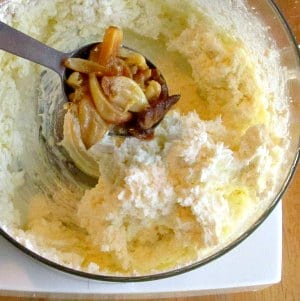 Add roasted garlic to a food processor of Whipped Feta 