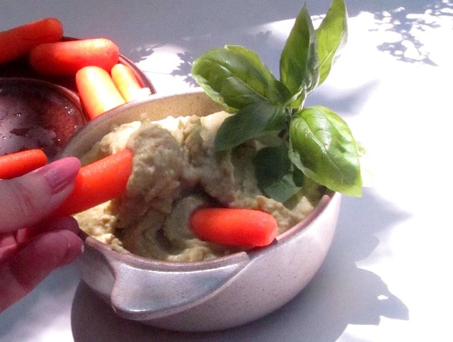 Bowl of Pesto Hummus served with carrots