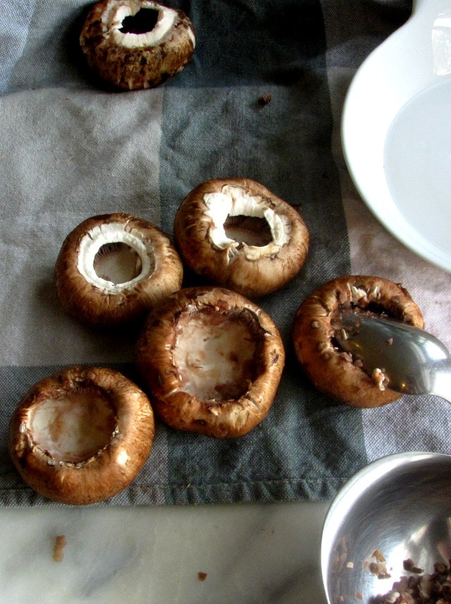 Preparing mushroom caps for stuffing.