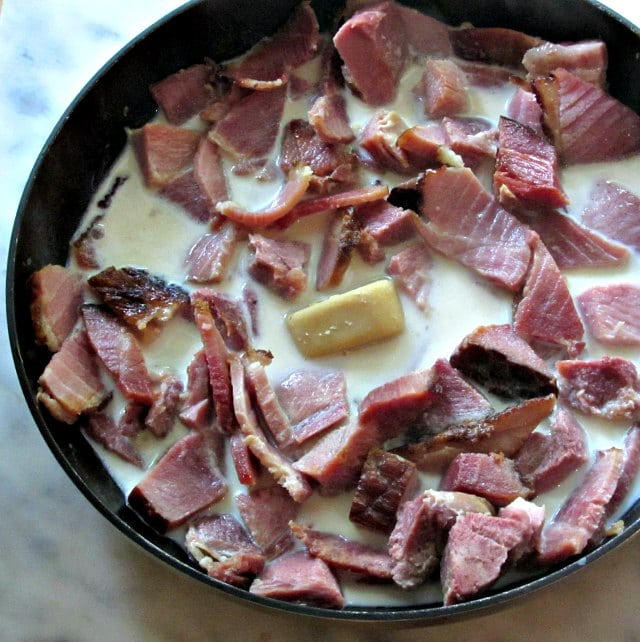 Skillet of ham with milk and a roux cube