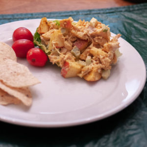 Curried Chicken Salad, plated with tomatoes and chips